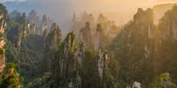 Dramatic rock formations surrounded by clouds in Zhangjiajie.