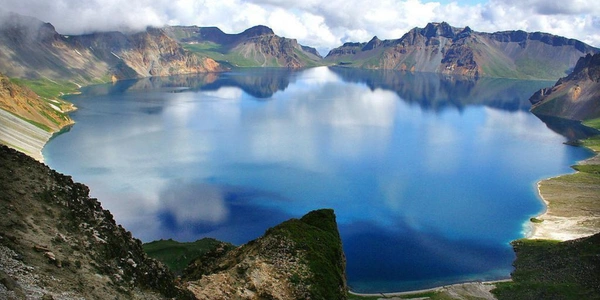 Heaven Lake at Changbai Mountain in Northeast China, featuring a pristine volcanic crater lake surrounded by rugged peaks and dramatic alpine scenery.