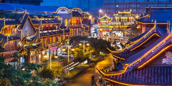 traditional Chinese-style architecture and vibrant city streets at night in Chengdu, China, a popular destination accessible with Malaysia Airlines flights.