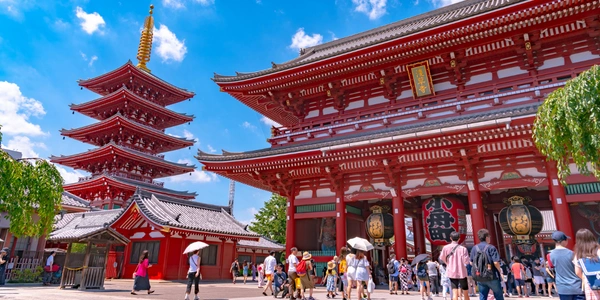 Visitors exploring Senso-ji Temple and a traditional five-story pagoda in Tokyo, Japan, one of the country's most iconic cultural landmarks and a popular destination for Malaysia Airlines travelers.