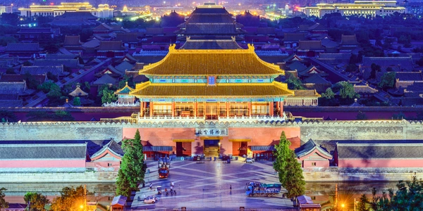The Forbidden City in Beijing with traditional palace rooftops and open courtyards.
