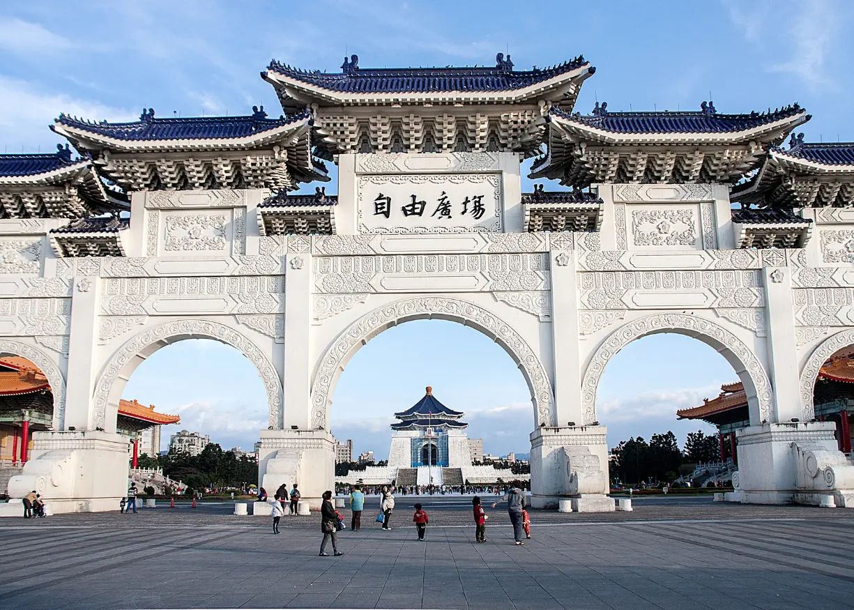 Chiang Kai-shek Memorial Hall in Taipei, Taiwan, featuring a grand white building with a blue octagonal roof, set in Liberty Square and surrounded by gardens, traditional gates, and cultural performance halls. A popular tourist site known for its historical exhibitions and Changing of the Guard ceremony.