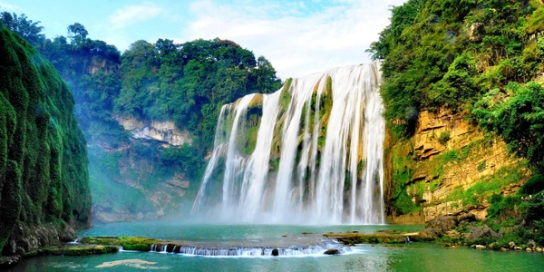 Detian Waterfall on the China-Vietnam border, featuring cascading waterfalls, lush subtropical forests, and emerald-green waters in one of China's most scenic eco-tourism destinations.